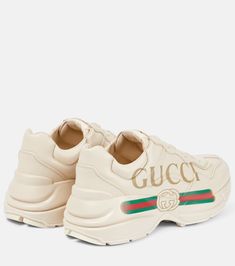 Find GUCCI Rhyton Leather Sneakers on Editorialist. Toe shape: round toe. Upper: calf leather. Sole: fabric insole, rubber sole. Closure: lace-up. Designer color name: Ivoire. Comes with a box. Made in Italy. Comes with dust bag. Gucci Rhyton, Italy Logo, Gucci Designer, Buy Gucci, Metallic Fabric, Leather Trainers, Gold Print, T Shirt And Jeans, Vintage Logo