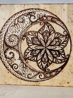 a wooden plaque with an intricate design on it