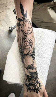 a person with a flower tattoo on their arm