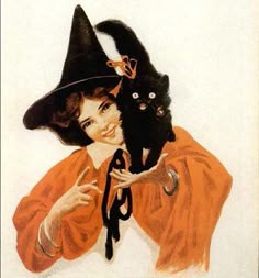 a woman holding a black cat wearing a witches hat