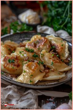 a plate full of pasta with shrimp and parsley on the side, sitting on a table