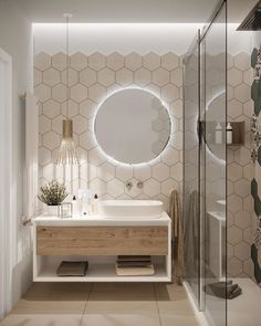 a bathroom with hexagonal tiles and a round mirror on the wall above the sink