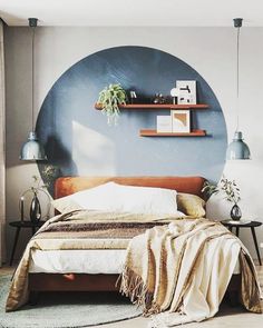 a bedroom with a large bed and shelves on the wall, along with two planters