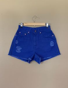 "High waisted 90's denim shorts. Made by Levi's in rare bright blue denim wash. Shorts are in excellent clean condition. Brand new with tags before I made them into cutoff shorts. These have been cutoff, distressed by hand, and washed once. Measurements are taken zipped or buttoned up and laid comfortably flat then x 2 for total circumference (inches) Tag Size 7 Levi's 560 100% Cotton Made in USA Waist 28\" Hips 42\" Length 13.5\" Inseam 2.5\" Rise 12\" leg opening circumference 26\" All items a 90s Inspired High Rise Jean Shorts For Spring, 90s Inspired Cutoff Bottoms For Summer, High Rise Jean Shorts For Summer In 90s Style, 90s Inspired High Rise Jean Shorts For Summer, Blue Distressed Shorts For Summer, 90s Inspired Denim Jean Shorts For Spring, High Rise 90s Inspired Summer Shorts, 90s Inspired High Rise Shorts For Summer, 90s Style Cutoff Jean Shorts In Medium Wash