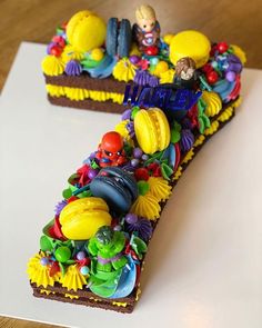 a cake shaped like the letter s is decorated with colorful candy and decorations on top