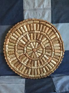 a woven basket sitting on top of a blue and white blanket