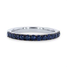 a white gold ring with blue sapphire stones on the sides and a thin band in the middle