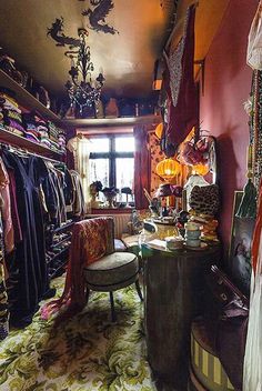 a room filled with lots of clothes and furniture