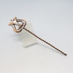 This lovely vintage hair stick is rich bronze metal in an ornate Lyre design with a real pearl accent.  It is a nicely sized piece measuring 7 1/8ths inches long and 1 7/8ths inches wide at the top.  This is in Excellent condition with no markings. We will send this to you in a lovely gift box for easy gift giving or safe storage. If you like vintage hair accessories, old silver, vintage jewelry, bolo ties and more, kindly check out my Etsy store at www.etsy.com/shop/PANDPF Bronze Vintage Necklace Gift, Lyre Design, Decorative Vintage Bronze Necklace, Antique Hair Pin, Vintage Bronze Hand-cast Necklaces, Art Nouveau Hair Pin, Vintage Hair Accessories, Bolo Ties, Metal Hair