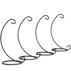 four black wire hangers on a white background