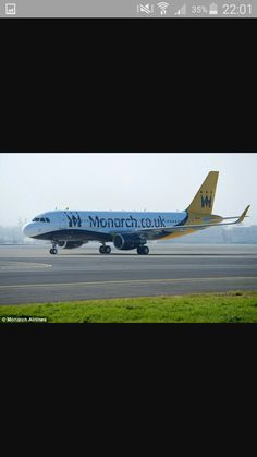 a blue and yellow plane is on the tarmac at an air port run way