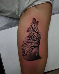 a woman's arm with a tattoo on it that has a tree in the shape of a heart