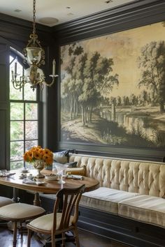 a dining room with a bench and painting on the wall