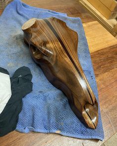 a wooden object laying on top of a blue towel