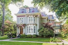 an old victorian style house with many windows