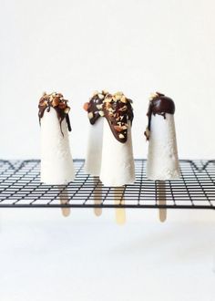 four ice cream cones are on a rack