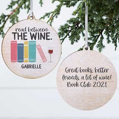 two wooden ornaments hanging from a tree with wine glasses and books on them, read between the wine and great books better friends