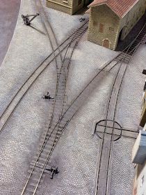 an aerial view of train tracks and buildings