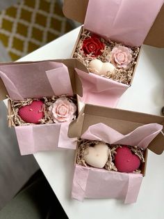 two pink boxes with hearts and roses in them