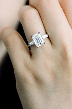 a woman's hand with a diamond ring on it