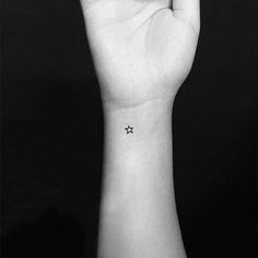 a small star tattoo on the wrist