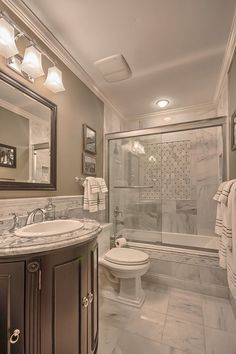 a bathroom with a sink, toilet and shower