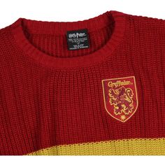 a red and yellow sweater with a crest on it