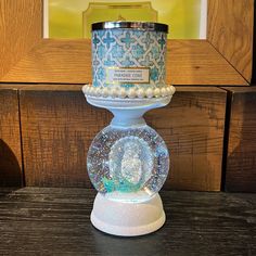 a candle holder with a glass ball on top