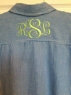 a blue and white checkered shirt with the initials on it