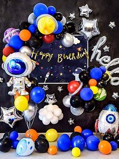 an astronaut themed birthday party with balloons and decorations