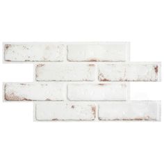 a white brick wall with rusted paint on the bottom and one in the middle