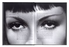 an open book with black and white photograph of woman's eyes