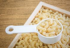 a wooden tray filled with macaroni and cheese