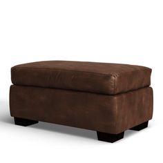 a brown ottoman sitting on top of a white floor