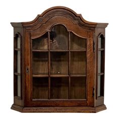 an old wooden bookcase with glass doors