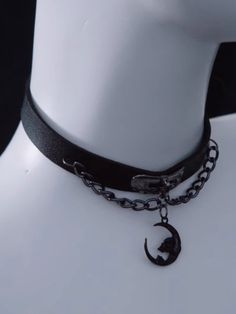 Elevate your gothic fashion with this stunning Gothic Black Moon Pendant PU Choker with Chains. Crafted from high-quality PU leather, this choker features a captivating black moon pendant. The intricate chain details add a touch of edginess. Adjustable for a comfortable fit. Emo Black Choker For Halloween, Black Emo Choker For Halloween, Grunge Black Choker For Festival, Black Choker For Alternative Fashion, Halloween Black Chain Choker, Black Metal Choker For Alternative Fashion, Gothic Black Jewelry With Moon Phase, Gothic Choker For Concert, Gothic Choker With Adjustable Chain For Festivals