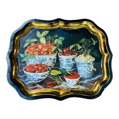 a painting of fruit in blue and white bowls on a gold rimmed serving tray