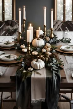 a dining room table with candles and plates