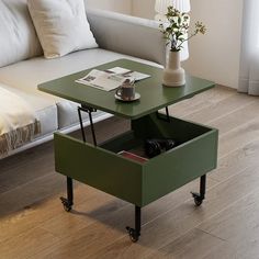 a coffee table with an open drawer on the bottom and wheels in front of it