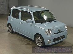 a small blue car parked in a garage