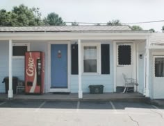 a blue building with two soda machines in front of it