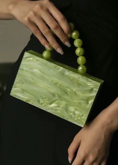 Introducing the Bead Handle Acrylic Mini Box Bag; an exclusive and elegant addition to any wardrobe. The box bag is adorned with a luxurious bead handle, crafted from beautiful acrylic, and showcases a stunning green hue. An elegant and tasteful must-have. Summer Formal Green Bags, Chic Beaded Rectangular Evening Bag, Trendy Green Box Bag For Party, Trendy Green Box Bag For Evening, Trendy Green Evening Box Bag, Elegant Green Summer Bag, Formal Handheld Green Box Bag, Trendy Green Clutch As Gift, Trendy Green Clutch As A Gift