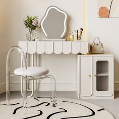 a white desk with a mirror, chair and vase on top of it in a room