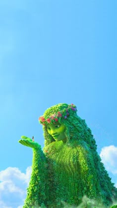 there is a very large green creature in the air with clouds behind it and blue sky above