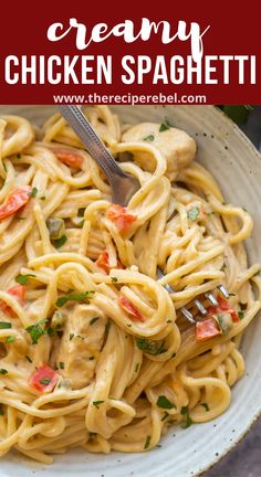 creamy chicken spaghetti in a white bowl with a fork