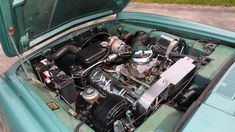 the engine compartment of an old green car