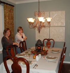 two women sitting at a dining room table