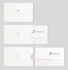 three white business cards with holes in the middle