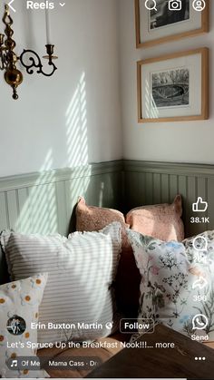 a bed with pillows and pictures on the wall