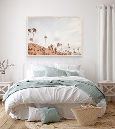 a bed with white sheets and pillows in a bedroom next to a painting on the wall